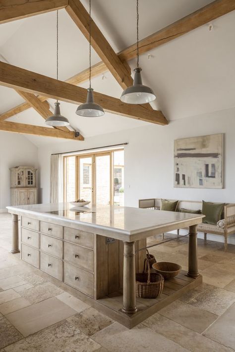 A bespoke modern rustic country kitchen by Artichoke with large island. This bespoke modern rustic kitchen, designed for a new build country house, takes influence from Flemish design. The large central kitchen island has a specialist finish to age the material and give it a rustic feel. The painted furniture forms a backdrop to the island and has classical detailing with raised and fielded panel doors.Primary materials: Oak, Bental White marble, hand painted furniture and bronze handles #bespok European Country Kitchen, Kirchen Design, Rustic Island, French Farmhouse Kitchen, Bespoke Kitchen Design, Rustic Country Kitchens, Rustic Kitchen Island, Country Kitchen Designs, Kitchen Glass