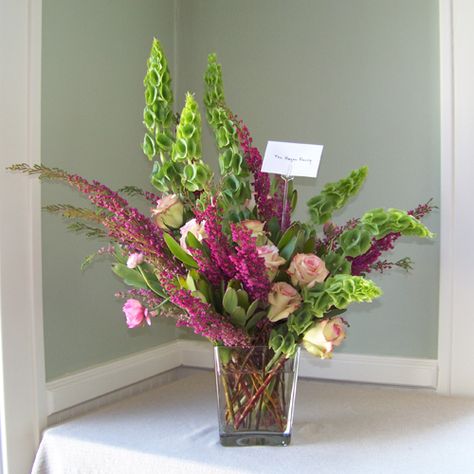 Sympathy arrangement with bells of Ireland, green leucadendron, Cezanne roses, pink ranunculus and heather Bells Of Ireland Arrangement, Bells Of Ireland Bouquet, Modern Wedding Diy, Ireland Decor, Valentine Flower Arrangements, Bells Of Ireland, Flower Room Decor, Contemporary Flower Arrangements, Lobby Ideas