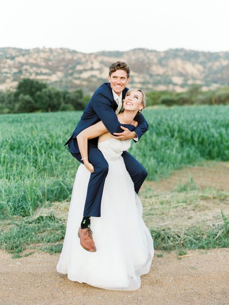 Bride giving groom a piggy back ride on a farm road with fields and mountains in the background. Full Belly Farm reception by film photographer Cavin Elizabeth Photography Bridal Carry Pose Reference, Piggyback Ride Drawing Reference, Piggy Back Ride Drawing Reference, Pose For Wedding, Tall Girl Short Guy, Ride Drawing, Farm Reception, Mountain Photoshoot, Save Videos