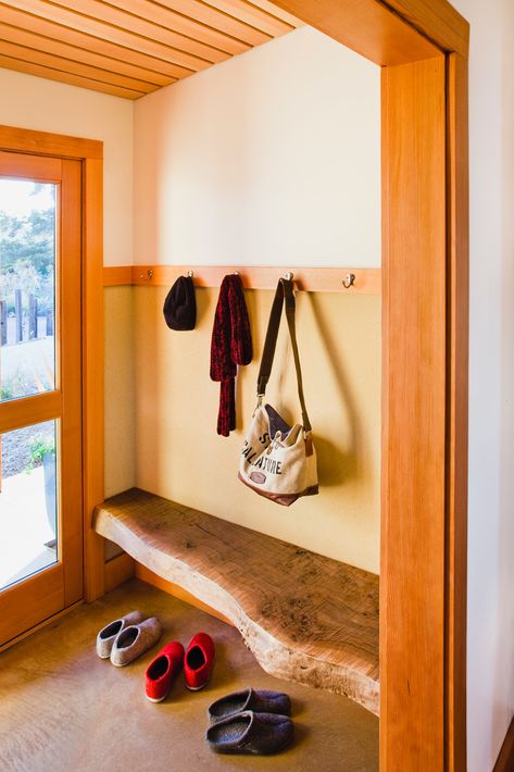 A live edge bench, harvested from the site, balances the carved door of the bathroom on the opposite end of the entry/mudroom. Live Edge Ideas, Images Of Kitchen Islands, Bench Coat Rack, Foyer Wallpaper, Coat Rack Bench, Edge Ideas, Diy Entryway Bench, Entry Mudroom, Rustic Entryway