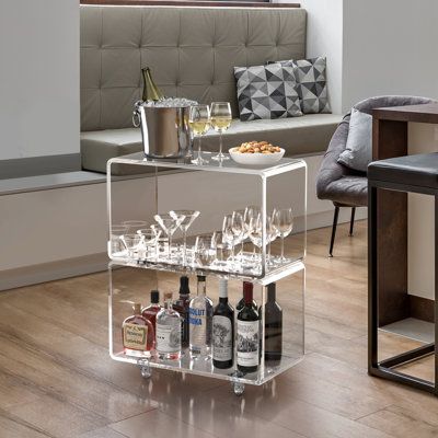 Designed to make your valuables be the centre of attention and look great in any room. This modern looking clear cart will elevate your experience to an entire new level. | Orren Ellis Crystal Bar Cart 30.0 x 23.0 x 12.0 in | C100182987 | Wayfair Canada Small Bar Ideas For Home, Small Bar Ideas, Shelf Cube, Acrylic Bar Cart, Texas Home Decor, Home Bar Areas, Small Bar, College Apartment Decor, Shop Chair