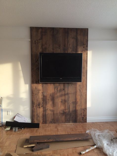 Wood wall, 1x12 stained floor color and grey wash to antique it! Hidden wires! Love it! Wood Wall Tv Ideas, Wood Wall For Tv, Wood Accent Behind Tv, Wood Tv Wall Ideas, Shiplap Wall Living Room With Tv, Tv Wall Decor Wood, Tv Wood Wall Ideas, Tv Wood Wall, Wood Wall Tv