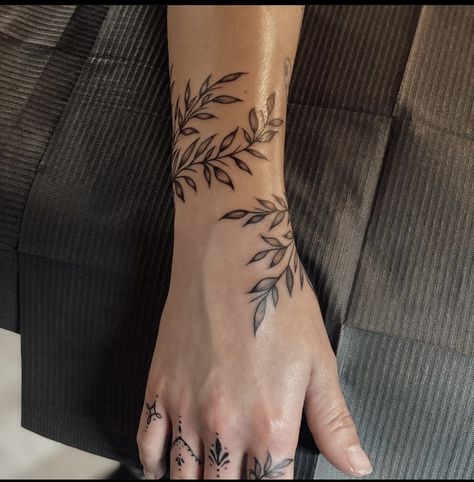 Wrist Tattoos For Women Leaves, Small Arm Vine Tattoo, Plant Forearm Tattoo Men, Masc Women Tattoo Ideas, Mens Leaves Tattoo, Vine Tattoo Wrist Wrap Around, Hand Tattoos Plants, Leaves Tattoo Around Arm, Sunflower Vine Wrap Around Tattoo