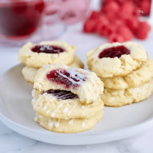 5-Ingredient Raspberry Cheesecake Thumbprint Cookies - The Fresh Cooky Thumbprint Cookies Raspberry, Cheesecake Thumbprint Cookies, Thumbprint Cookies Christmas, Cookies Raspberry, Raspberry Thumbprint Cookies, Almond Shortbread, Christmas Baking Cookies, Best Holiday Cookies, Thumbprint Cookies Recipe