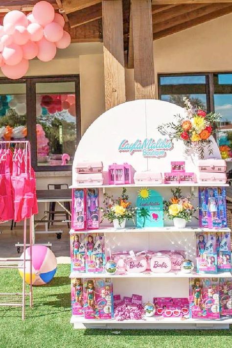 Take a look at this colorful Malibu Barbie birthday party! The party favor stand is amazing!! See more party ideas and share yours at CatchMyParty.com Party Decoration Business Ideas, Diy Party Favor Stand, Favor Stand Ideas, Party Favor Stand, Barbie Souvenir Ideas, Birthday Stand Ideas, Barbie Unicorn Birthday Party, Barbie Party Favors For Boys, Barbie Beach Birthday Party