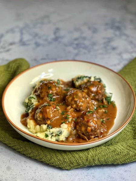 RECIPE: CHEESY IRISH MEATBALLS WITH GUINNESS ONION GRAVY – Maui Nui Venison Irish Meatballs, Pastele Stew, Venison Tenderloin, Venison Stew, Meatballs And Gravy, Fried Spring Rolls, Holiday Roasts, Cook Meat, Onion Gravy