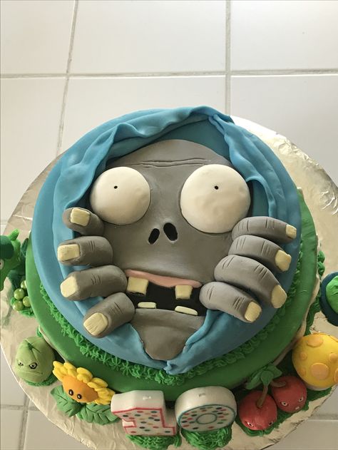 I made this Plants vs Zombies cake for my son's 10th birthday. It's a chocolate cake with chocolate ganache, & covered with fondant. The figures (except the pea shooter & lily pad, which my 6yr old made out of clay) were made out of gum paste. Fingers & face were fondant. Eyes were rice krispie treats covered with fondant. I've never made a layered cake, used fondant, or gum paste so I think it turned out great!! It was good too! Fondant Eyes, Zombie Birthday Cakes, Zombies Cake, Plants Vs Zombies Cake, Pea Shooter, Scary Halloween Cakes, Plants Vs Zombies Birthday Party, Zombie Cake, Zombie Birthday Parties