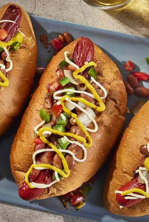 This Sonoran hot dog recipe features a bacon-wrapped hot dog, onions, peppers, salsa, beans, mustard, and mayonnaise.  #dinnerideas#dinnerrecipes#dinnerdishes#familydinnerideas#supper#supperideas Hot Dog Onions, Sonoran Hot Dog Recipe, Sonoran Hot Dog, Dogs Recipes, Hot Dog Recipe, Bacon Wrapped Hotdogs, Wrapped Hot Dogs, Grilling Hot Dogs, Hot Dogs Recipes