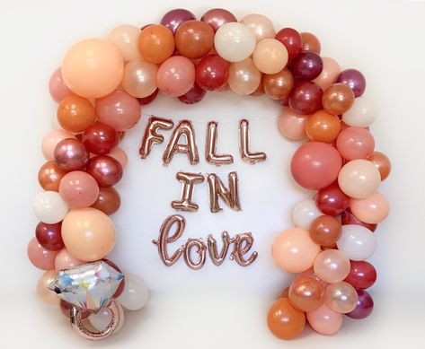 "Fall In Love with this Balloon Garland, perfect for your fall themed shower Features latex balloons in the following shades: Dusty Rose Shiny Peach Warm Cappuccino Pumpkin Spice Burgundy Leafy Red Ivory Tan EASY AND FUN! -This balloon garland kit contains all the balloons you need to make the latex balloon garland pictured, the \"FALL IN love\" phrase and rose gold ring balloon are add-on items from the drop down menu Also included: Step by step instructions for how to assemble the garland garl Fall Wedding Shower Balloon Arch, Fall In Love Balloon Arch, Bridal Shower Fall Ideas, Fallen In Love Bridal Shower Ideas, Bridal Shower Themes For October, Fall Themed Bachelorette Party Ideas, Bridal Shower Fall Outfit, Bridal Shower October, Falling In Love Bridal Shower Ideas