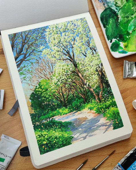 Photo of a sketchbook laid out on a desk surrounded by brushes and gouache paint tubes. The painting shows a pathway through trees and foliage on a sunny spring day. Gouache Landscape, Gouache Tutorial, Dutch Landscape, Paint With Me, Environment Painting, Gouache Illustrations, Posca Art, Twitch Stream, Gouache Art