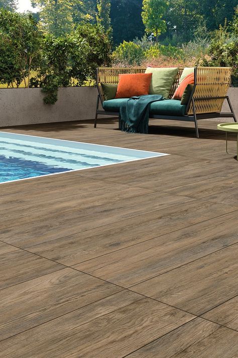 Styled wood effect porcelain tiles with no-slip properties enhance the value of pool decks and external pavings. Hard-wearing outdoor ceramics of the Fiemme Collection by Marca Corona with impressive finishes inspired by the wood look warm hues. 20 mm thickness surfaces design authentic, contemporary settings with impeccable elegance. High-performance outdoor tiles. Outdoor Wood Tiles, Wood Like Tile Flooring, Ceramic Wood Tile Floor, Pool Deck Tile, Wood Like Tile, Wood Effect Porcelain Tiles, Wood Deck Tiles, Porcelain Pavers, Porch Tile