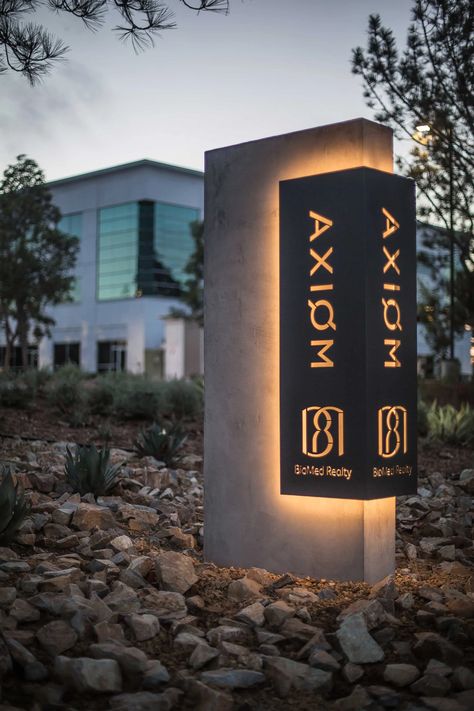 Axiom Exterior Monument Signage, Modern Outdoor Signage, Commercial Signage Exterior, External Signage Design, Entry Monument Signage, Hotel Entrance Signage, Outdoor Building Signage, Exterior Signage Design Entrance, Exterior Signage Design Ideas