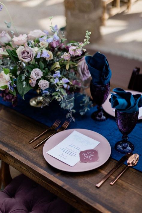 Manifesting in regal blue and purple palette throughout a romantic tablescape of crushed velvet, amethyst glass chalices, rose gold flatware and adorable acrylic place settings. Violet Table Setting, Plum And Navy Blue Wedding Table Settings, Purple Place Settings, Amethyst Wedding Theme, Navy And Purple Wedding, Arab Tea, Blue And Purple Palette, Purple Table Settings, Holland Wedding