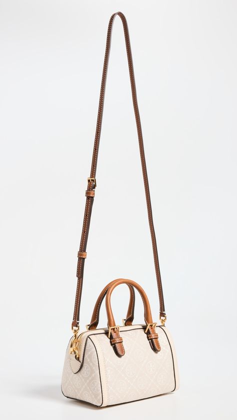 Find TORY BURCH T Monogram Petite Barrel Bag on Editorialist. Jacquard. Leather trim. Monogram pattern. Gold-toned hardware. Structured base with metal feet. Zip at top. Patch interior pocket. Optional, adjustable strap. Suede lining. Weight: 11oz / 0.31kg. Imported, Vietnam. Measurements: Height: 4.75in / 12cm Length: 7.5in / 19cm Depth: 4.25in / 11cm Strap drop: 21.75in / 55cm Handle drop: 2.25in / 6cm Barrel Bag Outfit, Limousine Car, T Monogram, Barrel Bag, Cute Handbags, Monogram Pattern, Tory Burch Bags, Tory Burch Bag, Leather Bags