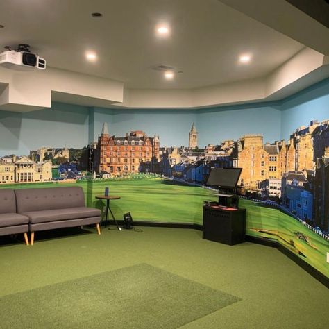 Designer Kristen M. of Kristen Mirabile Design used the beautiful 1st and 18th Holes, The Old Course at St. Andrews Links wallpaper mural to create an immersive experience in this golf simulator room. Even if you don't have a simulator, golf course murals are a beautiful way to bring your favorite course home with you. Photographer Evan Schiller specializes in golf course photography and has captured stunning shots from courses around the world. Golf Course Wallpaper, Golf Mural, Simulator Room, Golf Simulator Room, Golf Course Photography, Man Cave Design, Famous Golf Courses, Converted Garage, Golf Simulator