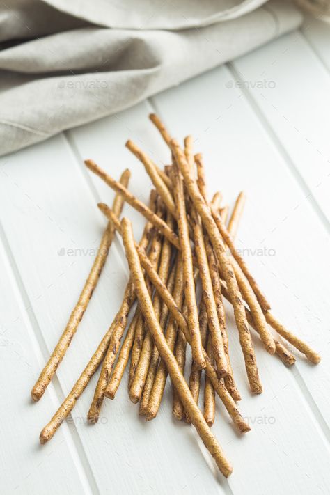 Salty pretzel sticks. by jirkaejc. Salty pretzel sticks on white table. Old Wooden Table, Snack Sticks, Pretzel Sticks, Fitness Logos, Fat Foods, Bakery Bread, Breadsticks, Savory Snacks, White Table