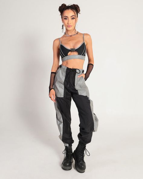 Bring the boom to the dance floor with the Thunder Shock Reflective Speed Clasp Crop Top! It has a scoop neckline, reflective underboob band, skinny straps, and silver reflective trim. Self: 82% Nylon, 18% Spandex Contrast: 88% Polyester, 12% Spandex Hand wash cold Do not bleach Hang dry Do not iron 90s Techno Rave Fashion, Rave Outfit For Cold Weather, Black And Silver Festival Outfit, Fishnet Rave Outfit, Reflective Streetwear, Rockstar Theme Outfit, Rave Style Outfits, Black Rave Tops For Streetwear, Edgy Black Harness For Festivals