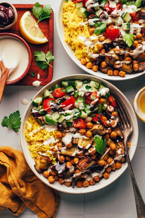 Overhead shot of two bowls of our Mediterranean-inspired chickpea nourish bowls Minimalist Recipes, Mediterranean Bowl, Nourish Bowls, Vegetarian Bowls, Mediterranean Bowls, Nourish Bowl, Vegan Greek, Easy Delicious Dinners, Tomato Cucumber