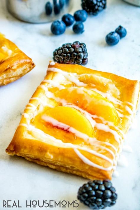 Finish Peach Cream Cheese Danish on the counter with blueberries and blackberries scattered around it. Peach Danish, Breakfast Danish, Peaches Cream Cheese, Cheese Danishes, Puff Pastry Recipes Dessert, Peach Filling, Pastries Recipes Dessert, Easy To Make Breakfast, Easy Breakfast Recipe