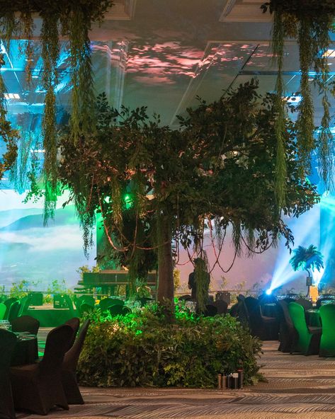 Welcome to the jungle 🌿🌺🌳 Transforming an empty event space into an enchanting rainforest gala - lush green foliage, vibrant florals, towering trees and dark, moody lighting. From rainforest galas to brand activations, we create stunning foliage & floral decor for any occasion! Contact us at info@event-trees.com and chat to our events team 📣 #floralarrangement #eventdecoration #eventdecor #eventinspiration #floraldecor #floraldesign #eventstyling #corporateeventstyling #corporateeventspl... Jungle Event Decor, Jungle Prom Theme, Unique Prom Themes, Moody Lighting, Rainforest Trees, Ibiza Party, Prom Themes, Brand Activations, Vibrant Florals