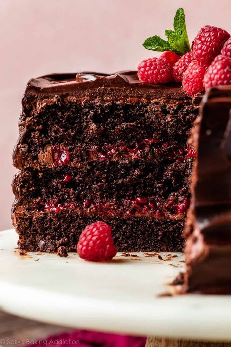 There's so much to love about this ultra-rich chocolate raspberry cake. Layers of moist dark chocolate sponge, silky chocolate buttercream, and homemade raspberry filling are enrobed in a luxurious chocolate raspberry ganache. This is a decadent dessert for anyone who loves the flavor combination of raspberries paired with deep, dark chocolate. Recipe on sallysbakingaddiction.com Chocolate Raspberry Layer Cake, Chocolate Raspberry Birthday Cake, Chocolate Cake Raspberry Filling, Dessert Photoshoot, Chocolate Cake With Raspberry Filling, Chocolate And Raspberry Cake, Raspberry Chocolate Cake, Chocolate Raspberry Cake Recipe, Raspberry Ganache