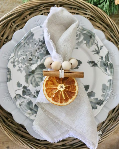 Sold as a set of 6. Handmade napkin rings are created with dried oranges and cinnamon sticks. The hemp twine and wooden bead accents add a special seasonal touch to your dining table. Combine with the Spring 2021 Décor Box Linen Frayed Napkins to style the most elegant holiday tablescape. Materials: Dried Orange, Cinnamon Sticks, Wood Beads, Twine Dimensions: 3” Ring Care: Store in a cool, dry place. Patience & Grace- Huntsville, Alabama Dusty Flannel Woodworking- Huntsville, Alabama Meet John a Napkin Rings Diy Ideas, Thanksgiving Napkin Rings, Handmade Napkins, Christmas Napkin Rings, Napkin Rings Diy, Hemp Twine, Dried Oranges, Holiday Tablescapes, Christmas Napkins