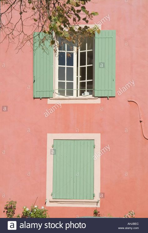 Download this stock image: Green shutters in pink wall in Provence, South of France - AHJBEC from Alamy's library of millions of high resolution stock photos, illustrations and vectors. Shutters Painted Ideas, Pink House Green Shutters, Salmon Pink House Exterior, Pink And Green House Exterior, Coral House Exterior, Pink House Exterior, Red Door House, Terrace House Exterior, Case Creole