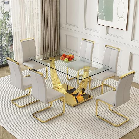 PRICES MAY VARY. ➤【7 Pieces Dining Table Set】: The modern and simple dining table and chair set with contemporary and luxurious appearance,and it can easily seat to 6 people comfortably. The kitchen table set can be used in dining room, guest room, living room, kitchen room, lounge home,extra room, etc. ➤【Sturdy & Durable Kitchen Table】: Made of 0.39" tempered glass tabletop and golden special-shaped bracket,this rectangle kitchen table is super stable and sturdy. With clear finish,making the su Gold Dining Table Set, Modern Kitchen Table And Chairs, Gold Dining Room Table, Blue Dining Room Decor, White Kitchen Chairs, Dining Table Set For 6, Glass Dining Table Set, Simple Dining Table, Dining Table Gold