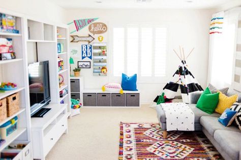 bright and colorful playroom decor, teen lounge area, bonus room decor, family room in bonus area with tv and wall decor Boho Playroom, Playroom Decoration, Modern Playroom, Teen Lounge, Diy Playroom, Living Room Playroom, Colorful Playroom, Kids Living Rooms, Basement Playroom