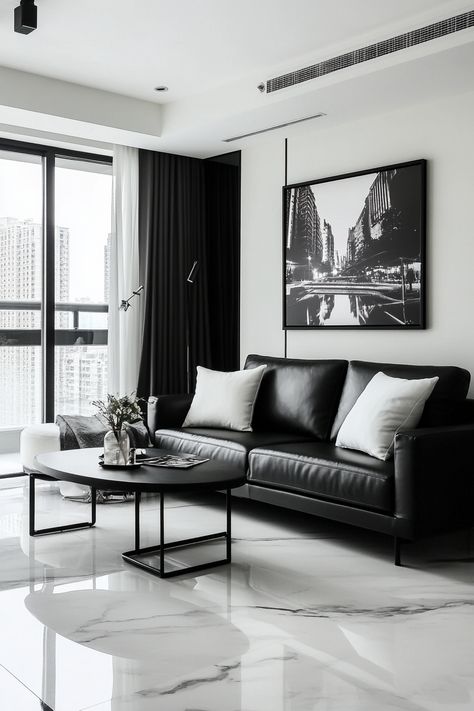 Elevate your living room decor with this sleek black and white design. The minimalist monochrome palette creates a sophisticated and stylish ambiance. Perfect for an urban apartment setting. #LivingRoomDecor #ModernDesign #InteriorInspo White Black Grey Living Room, Minimalist Living Room Black, Modern Monochrome Living Room, Black Grey Living Room, Monochrome Living, Monochrome Living Room, Black Leather Sofa, Minimalist Monochrome, Monochrome Style