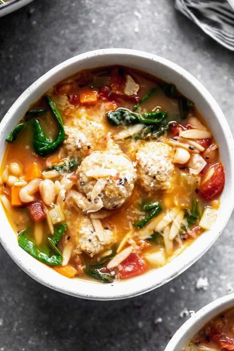 Minestrone with Chicken Meatballs is a hybrid of two comforting soups - minestrone and Italian wedding soup. With a rich, parmesan-infused broth, tons of veggies, whole-wheat orzo, and the most tender, flavorful chicken meatballs, this is a healthy winter soup worth making over and over again. Soups Minestrone, March Recipes, Italian Minestrone Soup, Creamy Tortellini Soup, Fall Eats, Soup With Chicken, Winter Soup, Ground Chicken Recipes, Meatball Soup