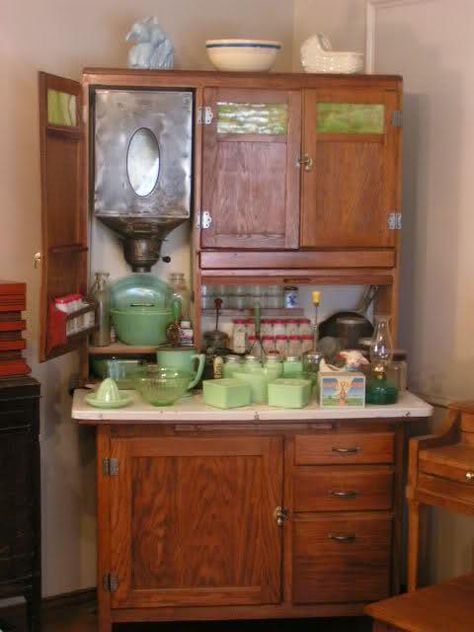 A Hoosier cabinet by Boone, circa 1910 with typical late Victorian kitchen implements. Both original and reproduction parts, fittings, hardware and utensils are widely available for Hoosier cabinets. Check out Hoosier Cabinet, for example.  Four to five feet wide, with built in sugar and flour bins (including a shifter at the bottom), numerous drawers and shelves, spice jars, racks for pots, pans and bowls, a condiment tray, rolling pin rack, cook book holder, and a zinc-lined bread box, the H Jade Dishes, Baking Cabinet, Antique Hoosier Cabinet, Green Dishes, Diy Coffee Station, Vintage Kitchen Cabinets, Hoosier Cabinets, Old Fashioned Kitchen, Kitchen Queen