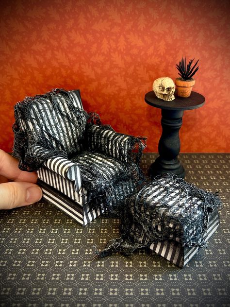 This haunted set of dollhouse furniture will look spooktacular in your miniature display or creepy dollhouse. The pieces are made with a wooden frame, batting, and black and white fabric striped upholstery. They have been shaded with black paint, draped with ghostly black cloth (stiff) and dry brushed with gray paint for a spooky shadow effect. Ottoman: Length: 2 1/8" Width: 2 1/8" Height: 1 3/8"   Couch: Length: 3" Width: 6 1/2" Height: 3 1/4"   Chair: Length: 2 1/2" Width: 2 7/8" Height: 3 1/8" Haunted Dollhouse Diy Ideas, Creepy Dollhouse, Dollhouse Couch, Monster High Dollhouse, Dollhouse Shelf, Halloween Dollhouse, Halloween Shadow Box, Halloween Furniture, Dollhouse Halloween