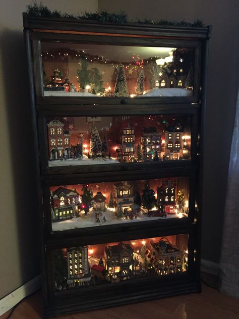 Refinished glass bookshelf for the village.  Also keep it safe from roaming, curious cats! Christmas Decorations On A Budget, Decorations On A Budget, Christmas Tree Village, Diy Christmas Decorations For Home, Diy Christmas Village, Christmas Village Houses, Christmas Village Display, Village Display, Diy Christmas Decorations Easy