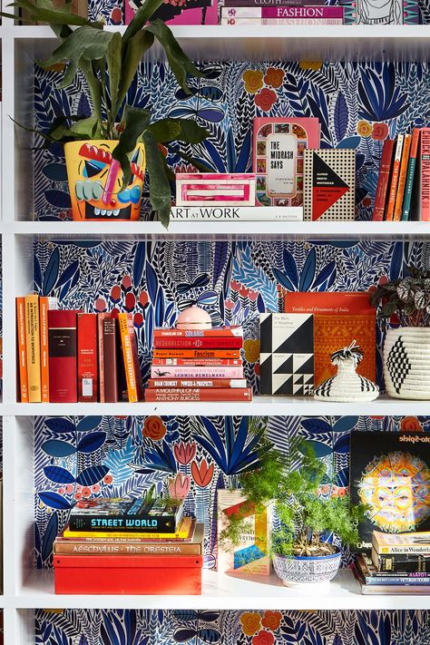 Bookcase Styling Maximalist, Maximalist Built In Shelves, Bookshelves Painted Inside, Knick Knack Display Ideas Living Rooms, Wallpaper Shelves Bookshelves, Wallpaper Backed Shelves, Wallpaper Behind Shelves Living Room, Maximalism Shelves, Wallpaper Back Of Bookshelf