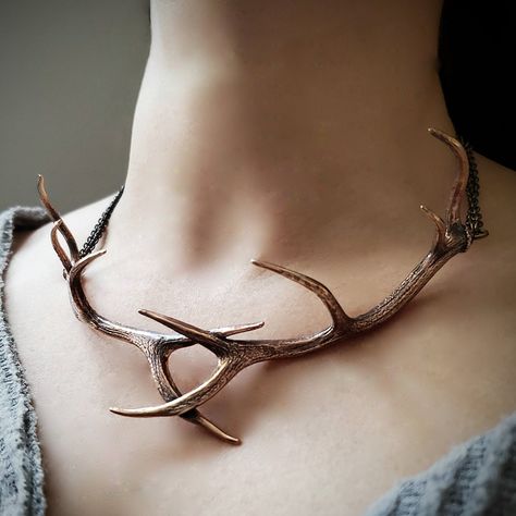 "I have crossed two of my massive elk antlers and cast them into one solid  bronze choker that will surely be the hit of the occasion. The finished piece is a combination of primal elegance and high fashion.  The Antlers are textured on both sides and it is finished with burnished bronze chains and findings.  The Antlers measure 5-3/4\" x 2-1/4\" with an overall end to end length of 18\". MOON RAVEN DESIGNS: Please check out the rest of our shop by clicking: http://www.etsy.com/shop/mrd74?ref=si Elk Antler, Antler Necklace, Elk Antlers, Fantasy Jewelry, Choker Necklaces, Antlers, Cute Jewelry, Body Jewelry, Elk