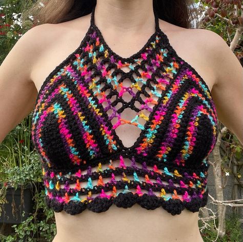 Get ready to make a bold statement this summer with our stunning handmade crochet crop top. Designed with a caged halter style, this eye-catching piece features vibrant multicoloured stripes against a sleek black background. Embrace the sunny vibes and show off your unique style with this trendy summer top. Key Features: -Handmade crochet crop top, perfect for summer days and nights. -Caged halter design adds a touch of edginess and uniqueness. -Vibrant multicoloured stripes bring a burst of col Edgy Crochet, Sunny Vibes, Modern Crochet Patterns, Crochet Crop Top Pattern, Crop Top Designs, Crochet Halter, Crochet Crop, Crochet Halter Tops, Modern Crochet