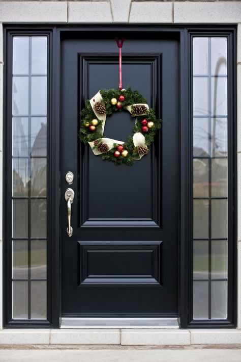 Here's a truly bespoke black door, with silver hardware, flanked by a pair of smoked glass windows. Black Front Door, Front Door, Wreath, Christmas Decorations, Doors, Christmas, Black