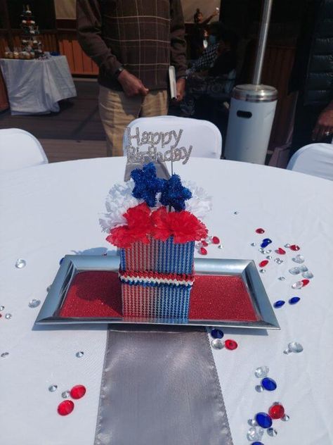 Add a pop of color to your table decor by crafting a stunning centerpiece. Arrange red & white paper flowers along with blue stars and a silver glittery happy birthday topper in a box embellished with red & blue rhinestone ribbons. Place this box on a decorative silver tray lined with a red glitter formic sheet generating a chic visual appeal. Scatter red, blue & white acrylic crystal beads all over the table for a whimsical display. Happy Birthday Topper, Amber Wedding, White Paper Flowers, Party Decorations Table, Home Decor Photography, Dream Setup, Event Decor Ideas, Birthday Topper, Rhinestone Sticker