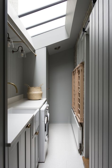 A functional use of a compact space in this utility room in a recently completed project in Dartmouth Park, North London. Ideal components of a utility are a rail for hanging, sink, drying rack, integrated laundry basket and a bench large enough to fold clothes. London Utility Room, Utility Room With Clothes Rail, Small Narrow Utility Room, Utility Room Hanging Rail, Utility Room In Kitchen, Utility Drying Rack, Long Utility Room, Windowless Utility Room, Utility Room Narrow