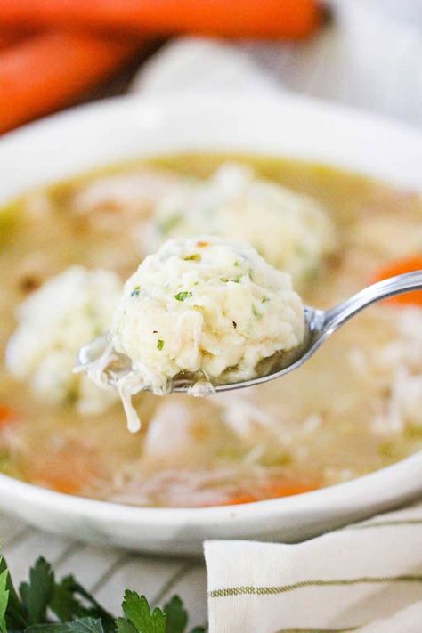 A spoon holding a dumpling over a bowl of chicken and dumplings soup. Chicken Dumpling Soup Healthy, Healthy Chicken Dumpling Soup, Fluffy Dumplings For Chicken And Dumplings, Chicken Soup Dumplings Trader Joes, Trader Joe’s Chicken Soup Dumplings, Homemade Chicken And Dumplings, Dumplings For Soup, Chicken And Dumplings, Vegetable Soup