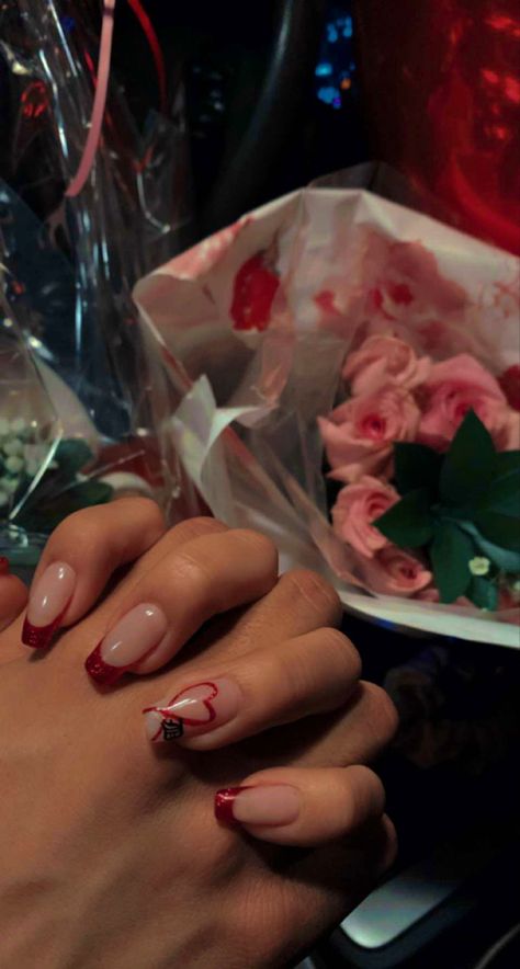 Couple holding hands portraying inspirational nail design for Valentine’s Day. Nail design is red glitter French tips except for the ring finger being red glitter heart and initial of significant other on the bottom right corner of the nail. Background consists of pink roses in a car setting. Initial M, Classy Acrylic Nails, Prom Nails, Nail Inspo, Acrylic Nails, Initials, Nail Designs, Nails