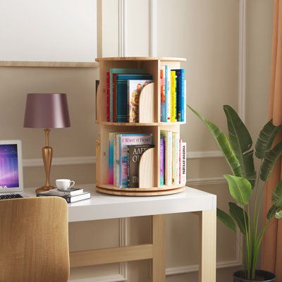 This 360-degree rotating bookshelf is made with high-quality solid wood. Featuring a 4-tier design, you can organize a variety of different items with ease such as books, vases, albums, etc. With a modular stackable design, you can also remove levels from the bookshelf and fit them into small spaces. | Latitude Run® Solid Wood Standard Bookcase Brown 27.0 x 18.0 x 18.0 in | C010997197_1088480038 | Wayfair Canada Small Desk Bookshelf, Book Storage Ideas For Small Spaces, Cute Bookshelf Ideas, Book Storage Small Space, Green Bookshelf, Round Bookshelf, Green Bookshelves, Bookshelf Inspo, Tabletop Bookshelf