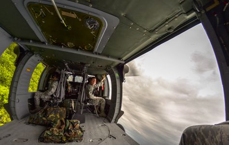 Inside shot of a UH-60 Blackhawk helicopter during a banked turn Helicopter Inside, Mercenary Aesthetic, Blackhawk Tactical, Adidas Wallpaper Iphone, Modern Warrior, Cheap International Flights, Adidas Wallpaper, Black Hawk Helicopter, Military Reference