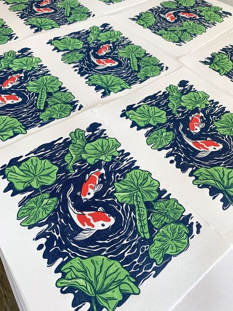 Overlapping blue, green, and red artwork featuring two koi fish swimming amongst water lilies. Koi Block Print, Koi Fish Block Print, Multi Block Printmaking, Multi Layer Linocut, Multi Block Lino Print, Koi Pond Illustration, Multicolor Linocut Prints, Layered Lino Print, Koi Fish Linocut