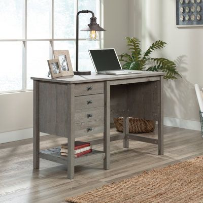 A simple desk that packs a big punch: this desk from the Tremont collection ships you off to a land far away with its stylish design and multi-functionality. This coastal desk features two drawers with full extension slides, perfect for storing extra sticky notes, a stapler, and that stash of candy. The lower drawer of this single pedestal desk holds letter-size hanging files so all of your most important documents are organized and easy to find. A lower open shelf for additional storage of book Coastal Desk, Cottage Desk, Desk With Storage, Pedestal Desk, Simple Desk, Hanging Files, Coastal Design, Open Shelf, Office Furniture Desk