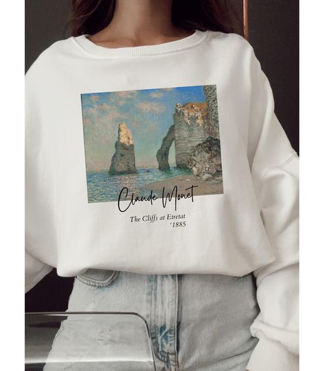 Gildan 18000 **If you are S get M or L for loose-oversized look. If you are L get XL or 2XL. If your size is not in stock please reach out so we can double check for you. **Apparel/design colors may vary across devices. Ideal for any situation, a unisex heavy blend crewneck sweatshirt is pure comfort. These garments are made from polyester and cotton. This combination helps designs come out looking fresh and beautiful. The collar is ribbed knit, so it retains its shape even after washing. There Artsy Graphic Design Crew Neck T-shirt, Artsy Crew Neck T-shirt With Custom Print, Artistic Oversized Crew Neck Sweatshirt, Artistic Crew Neck T-shirt With Printing, Monet Tshirt, Art Sweater, Artsy Outfit, Famous Art, Claude Monet