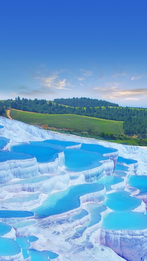 Pamukkale is a traveller's delight and a geological phenomenon. It is a town in western Turkey best known for its mineral-rich thermal waters that flow down the bright white terraces of a steep valley side. Cotton Castle, Pamukkale Turkey, Istanbul Photography, Pamukkale, Photo Awards, Natural Pool, Stunning View, Heritage Site, Hot Springs