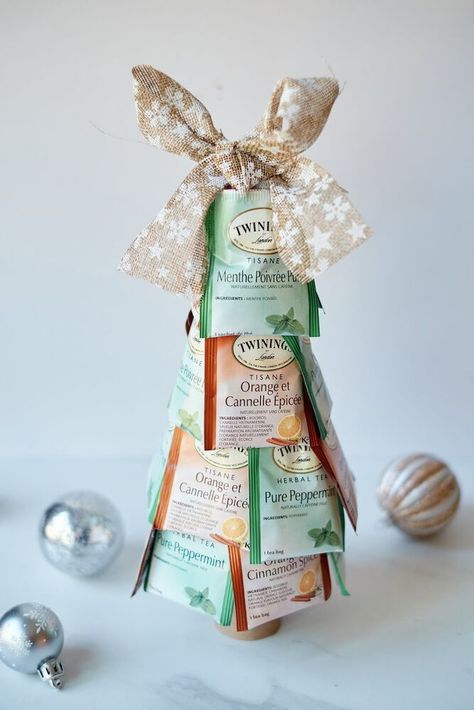 If you're looking for a cheap but thoughtful Christmas gift, you can't go wrong with this tea bag Christmas tree!﻿When you just don't have enough money to give gifts, but you want to anyway, this Christmas tea tree is an excellent thrifty gift idea. Supplies 1 Styrofoam cone (7 inches)2 packages of tea bags (approx. 10-12 of each)Bow (optional)Toilet paper tube (optional) Sort Your Tea Remove tea bags from the boxes. Sort by colors if you have different types. Attach Bags Laye… Free Printable Christmas Cards, Alternative Christmas, Cone Christmas Trees, Alternative Christmas Tree, Enough Money, Christmas Gifts For Coworkers, Thoughtful Christmas Gifts, Free Christmas Printables, Rustic Christmas Tree