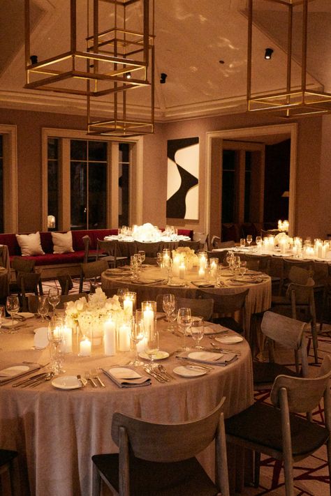 A luxurious wedding reception setup with round tables adorned with white floral centerpieces and surrounded by warm candlelight, creating an elegant and romantic ambiance. The scene is enhanced by chic decor and modern chandeliers, perfect for a high-end celebration. : #LuxuryWedding #WeddingReception #ElegantWedding #CandlelitWedding #WeddingInspiration Wedding Round Table Candles, Candlelit Wedding Reception Round Tables, Wedding Reception Circle Tables, Table Lamps Wedding, Round Table With Candles, Round Table Candles, Centerpieces Wedding Round Table, Wedding Reception Round Tables, Round Wedding Table Decor